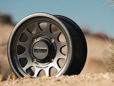 Method 414 Gloss Graphite Bead Grip® UTV Wheel with 12-window design, bead hump, and 1600 lb load rating for dunes and rugged terrain.