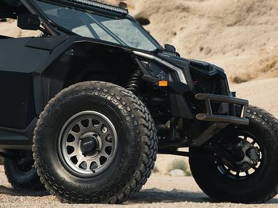 Method 414 Gloss Graphite Bead Grip® UTV Wheel with 12-window design, bead hump, and 1600 lb load rating for dunes and rugged terrain.