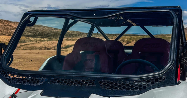 Moto Armor full glass windshield with vents and billet mounts for Voodoo Riders Kawasaki KRX 1000 cage, featuring wide view and durable frame.