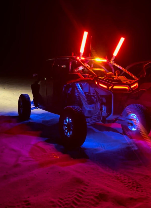 UTV with RGB rock lights and LED whips glowing on the dunes at night | Dunes 2 Dezert