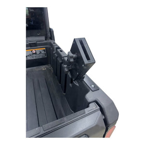 Can-Am Defender HD10 chainsaw mount by AJK Offroad holding a saw on the bed rail