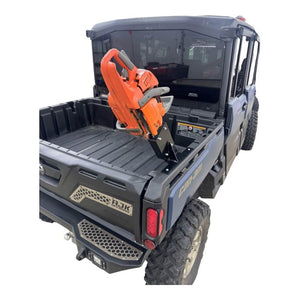 AJK Offroad Can-Am Defender chainsaw mount with HDPE holder on bed rail, angle view