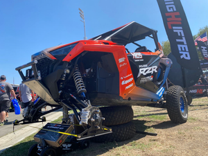 Pair of High Lifter powder-coated steel alignment plates for 4/137 and 4/156 UTV hub bolt patterns, shown with the included angle finder