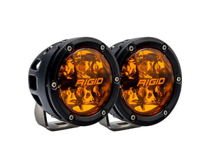 Rigid 360-Series 4in Amber PRO fog lights with white housing, 3,060 lumens, and amber backlight for dust and fog visibility.