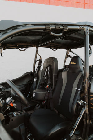 Kawasaki KRX 1000 front bump seat for kids, UTV Mountain Accessories, installed on off-road vehicle, with padded design and safety features.