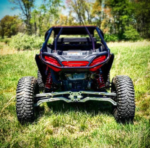 L&W Fab Polaris RZR Turbo S direct bolt radius rods installed on off-road vehicle for improved suspension performance.
