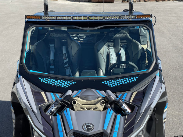 Moto Armor full glass windshield for Can-Am Maverick X3 with Voodoo Riders cage, featuring vents, DOT glass, and billet mounts.