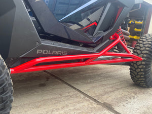 L&W Fab Polaris RZR Pro R 2-seat rock sliders and tree kickers installed on side of off-road UTV for protection.