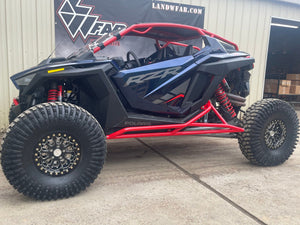 L&W Fab Polaris RZR Pro R 2-seat rock sliders and tree kickers installed on off-road vehicle for protection and durability.