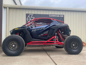 L&W Fab Polaris RZR Pro R 2-seat rock sliders and tree kickers installed on side of off-road UTV for protection and style.