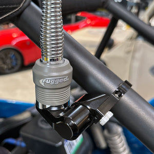 Close-up of Rugged Radios adjustable antenna mount clamped to off-road roll cage tubing
