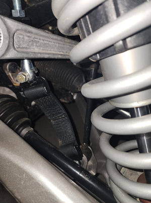 MTS Off-Road RZR Pro R Turbo R front limit strap kit installed on a Polaris RZR, showing the shock and strap attachment points.