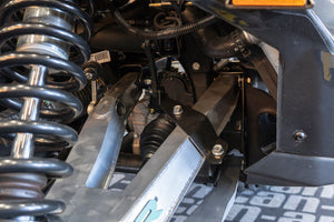Bolt-on Smart Shock brackets for CAN-AM X3 HCR control arms, made from HCR steel with black powder coat and fast, drill-free install