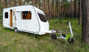 Trailer-Tug Monster-Tug towing device with rugged design, shown attached to a camper on a mountain trail.