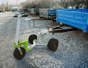 Trailer-Tug Monster-Tug towing flatbed truck carrying gravel on a four-square trailer.