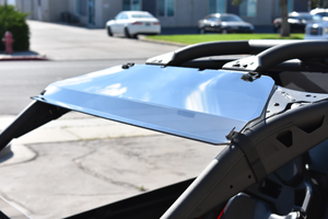 UTVZILLA tinted polycarbonate visor installed on a Can-Am X3 with factory roof and roll cage