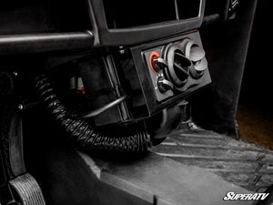 SuperATV cab heater installed under the dash of a Polaris Ranger XP 900, with the coolant hose routed below
