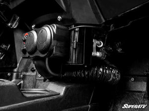 SuperATV cab heater installed under the dash between the seats of a Polaris RZR S 1000