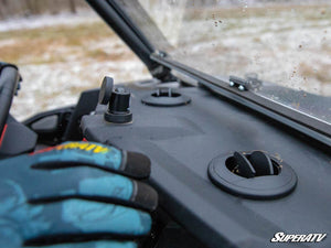Rider adjusting a SuperATV defrost vent on the Polaris RZR XP 1000 dash