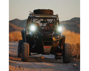 Pair of Rigid Adapt XP LED lights with GPS beam adjustment, aluminum housing, and amber covers for extreme powersports applications