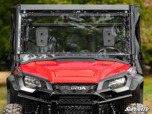 SuperATV MaxDrive power flip windshield on a Honda Pioneer 1000, angle view