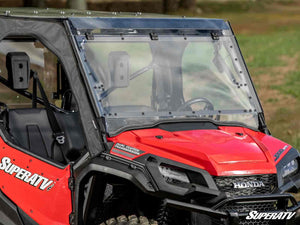 SuperATV MaxDrive power flip windshield on a Honda Pioneer 1000, installed close-up