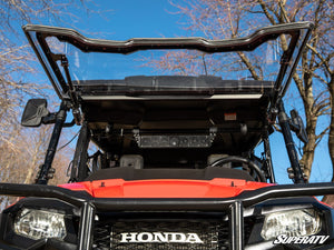 SuperATV MaxDrive power flip windshield on a Honda Pioneer 700, installed close-up