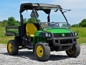 SuperATV flip windshield on a John Deere Gator, installed close-up