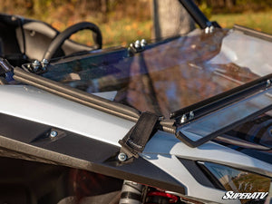 SuperATV flip down windshield on a Kawasaki Teryx KRX 1000, installed close-up