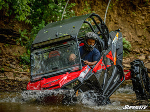 SuperATV flip windshield on a Polaris RZR, installed close-up