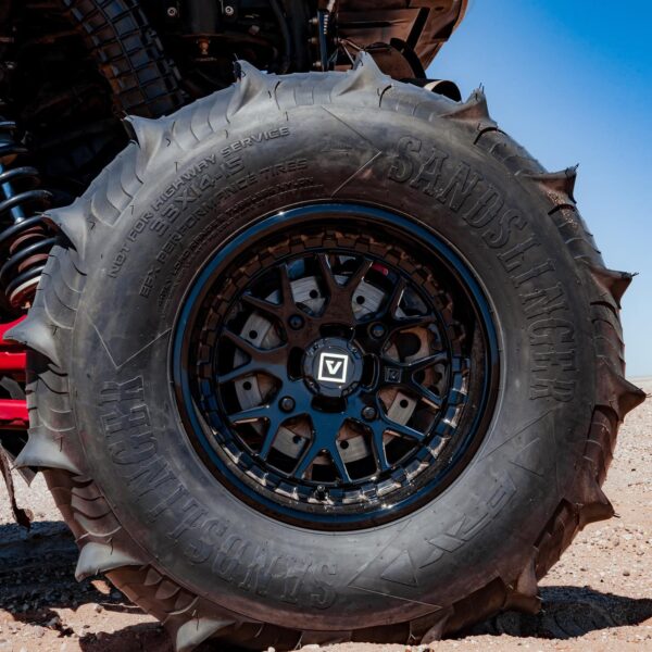 wheel with paddle tires close up in dunes