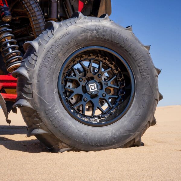 wheel with paddle tire in sand dunes